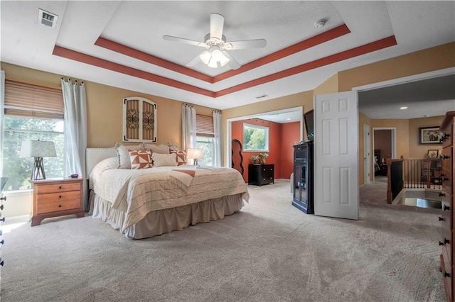 15801 Parkhill St, Overland Park, KS 66221 - bedroom featuring light colored carpet, a tray ceiling, baseboards, and a ceiling fan