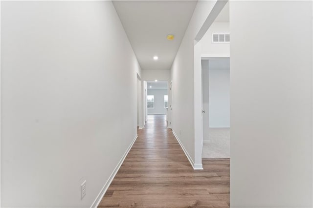 2208 Crestview Pl, Raymore, MO 64083 - hallway featuring wood finished floors, baseboards, and recessed lighting
