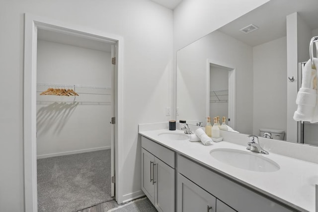 2208 Crestview Pl, Raymore, MO 64083 - bathroom with double vanity, toilet, and a spacious closet