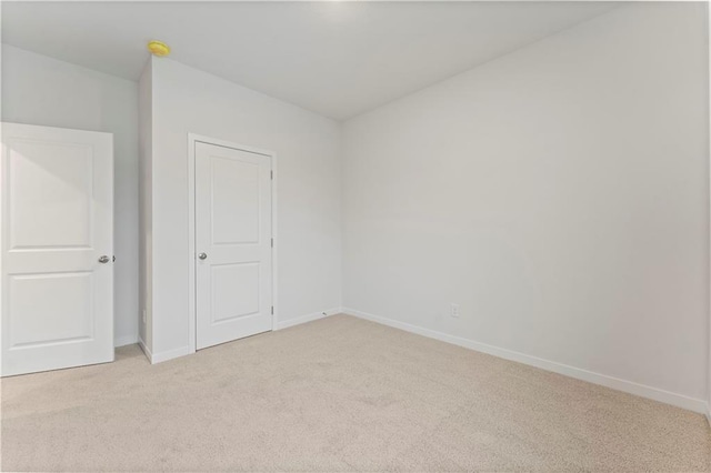 2208 Crestview Pl, Raymore, MO 64083 - unfurnished bedroom with light carpet and baseboards