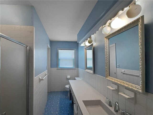 6317 Sherwood Ln, Shawnee, KS 66203 - full bath with tile walls, a stall shower, wainscoting, tile patterned floors, and toilet