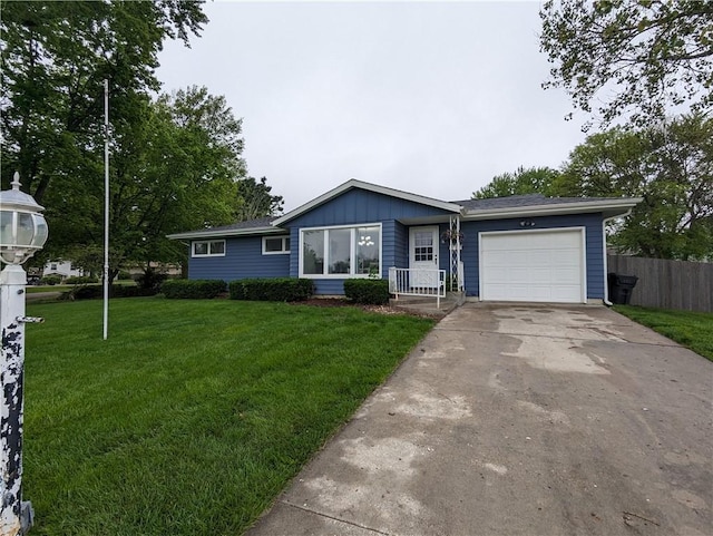 400 Pawnee Ave, Hiawatha, KS 66434 - ranch-style house with a garage, board and batten siding, and driveway