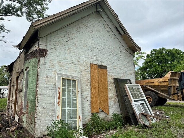 35 W 3rd St, Adrian, MO 64720 - view of side of home featuring brick siding and stone siding