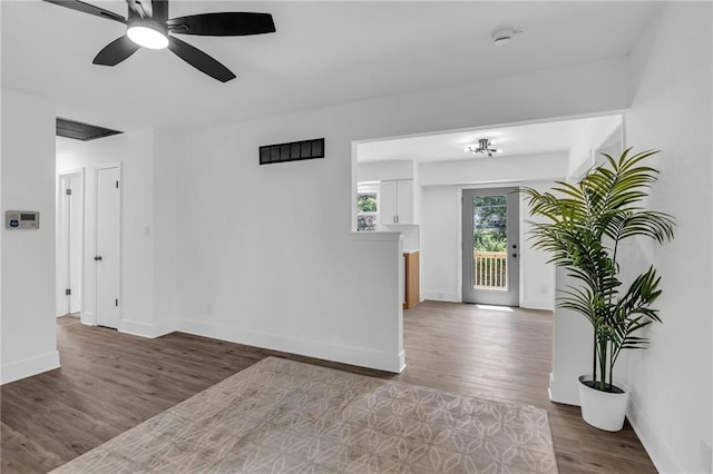 8823 E 111th St, Kansas City, MO 64134 - unfurnished room with wood finished floors, baseboards, and ceiling fan