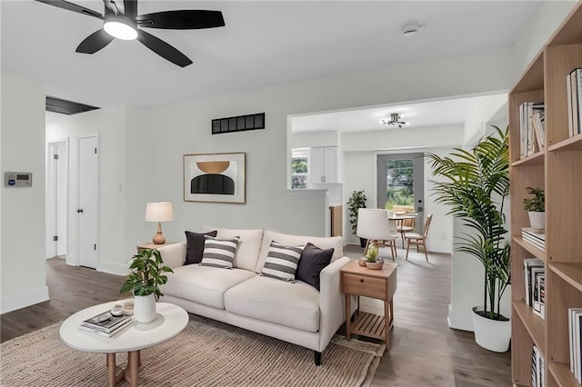 8823 E 111th St, Kansas City, MO 64134 - living area featuring wood finished floors, baseboards, and a ceiling fan