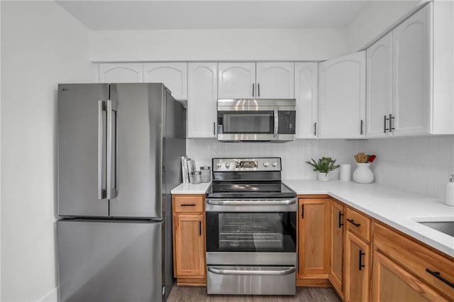 8823 E 111th St, Kansas City, MO 64134 - kitchen with stainless steel appliances, light wood-style flooring, and light countertops