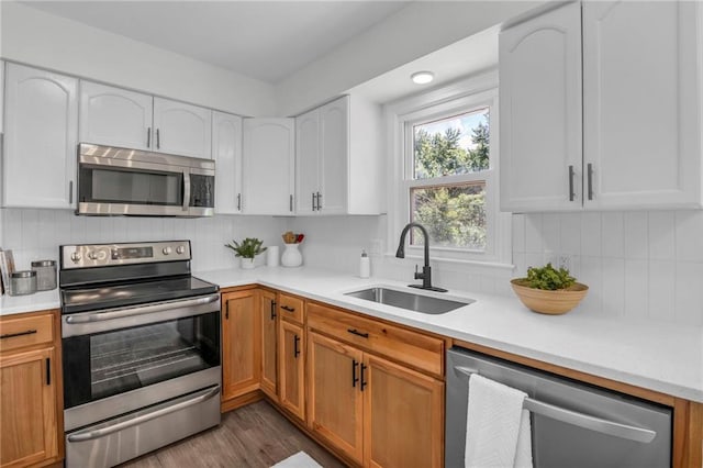 8823 E 111th St, Kansas City, MO 64134 - kitchen featuring stainless steel appliances, a sink, light countertops, and backsplash
