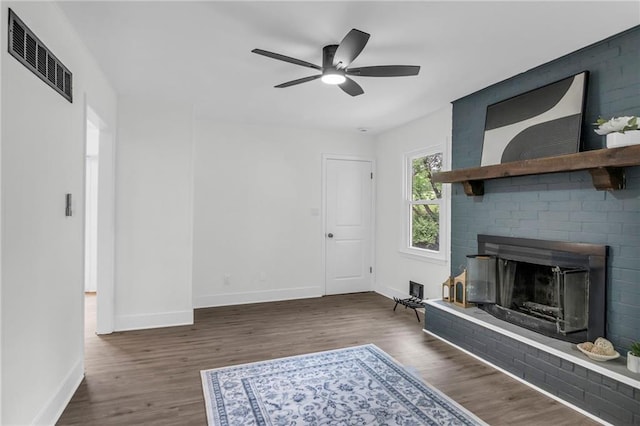 8823 E 111th St, Kansas City, MO 64134 - unfurnished living room featuring wood finished floors, baseboards, and a ceiling fan