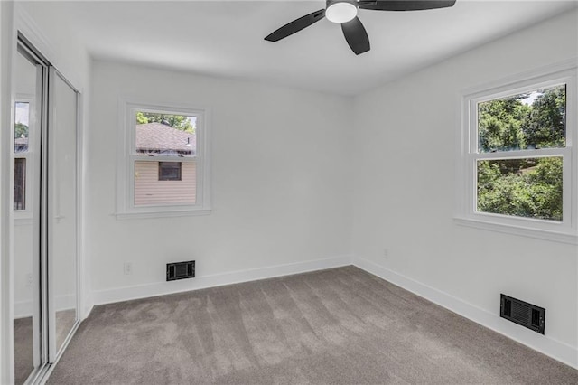 8823 E 111th St, Kansas City, MO 64134 - unfurnished bedroom with carpet, baseboards, ceiling fan, and a closet