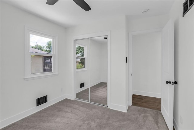 8823 E 111th St, Kansas City, MO 64134 - unfurnished bedroom featuring carpet flooring, a closet, baseboards, and ceiling fan