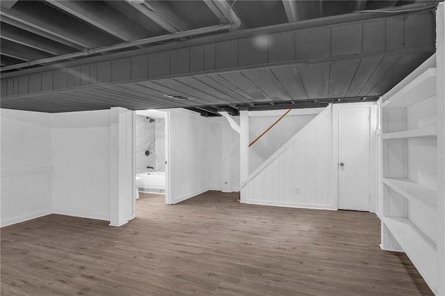 8823 E 111th St, Kansas City, MO 64134 - finished basement featuring wood finished floors, stairs, and baseboards