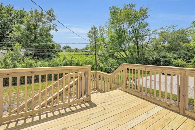 8823 E 111th St, Kansas City, MO 64134 - wooden deck with view of wooded area