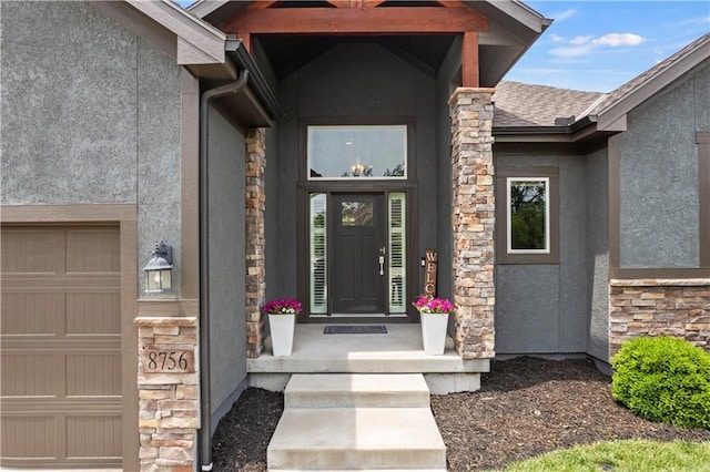 8756 Houston St, Lenexa, KS 66227 - entrance to property featuring stone siding, stucco siding, and a garage