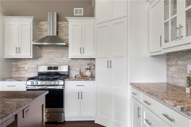 8756 Houston St, Lenexa, KS 66227 - kitchen featuring wall chimney exhaust hood, gas stove, tasteful backsplash, white cabinetry, and light stone countertops