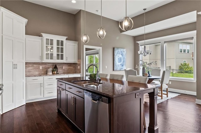 8756 Houston St, Lenexa, KS 66227 - kitchen with stainless steel dishwasher, a kitchen breakfast bar, dark stone counters, a high ceiling, and dark wood-style floors