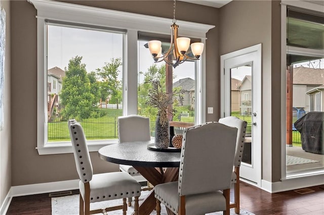 8756 Houston St, Lenexa, KS 66227 - dining room featuring a chandelier and dark wood-style floors