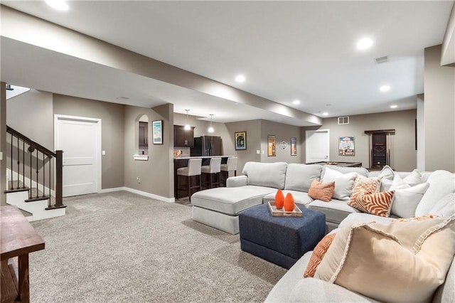 8756 Houston St, Lenexa, KS 66227 - living room featuring light colored carpet, recessed lighting, stairway, and bar