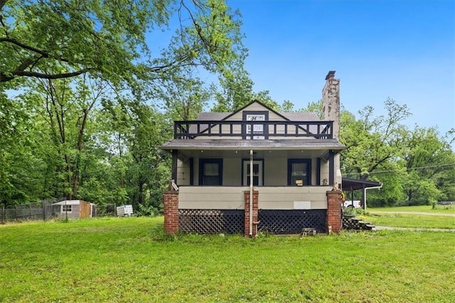7508 Walnut St, Pleasant Valley, MO 64068 - view of front of house featuring a front lawn, a chimney, and a balcony