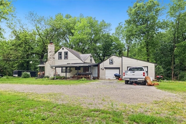 7508 Walnut St, Pleasant Valley, MO 64068 - view of front of house with a front lawn, a chimney, and an attached garage