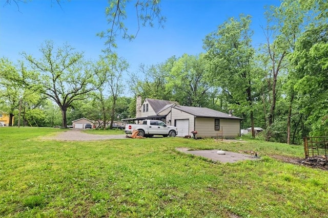 7508 Walnut St, Pleasant Valley, MO 64068 - view of green lawn featuring a garage and driveway