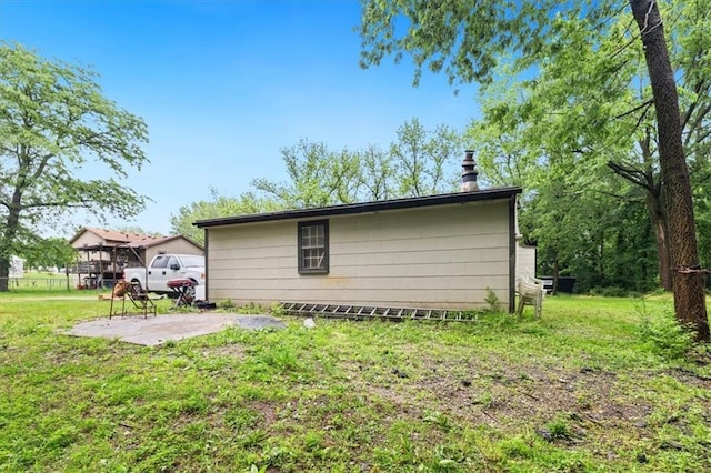 7508 Walnut St, Pleasant Valley, MO 64068 - view of side of home with a lawn and a patio