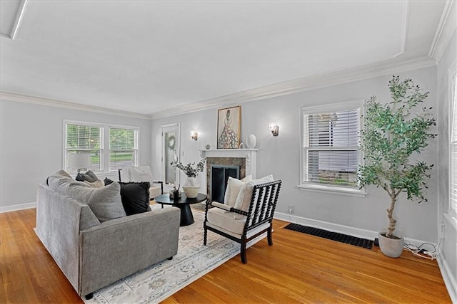 7224 Ward Pkwy, Kansas City, MO 64114 - living area with ornamental molding, light wood-style flooring, a fireplace, and baseboards