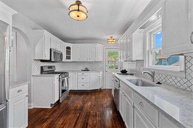 7224 Ward Pkwy, Kansas City, MO 64114 - kitchen featuring appliances with stainless steel finishes, a sink, dark wood-style floors, and white cabinets