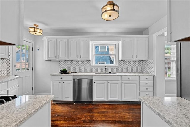 7224 Ward Pkwy, Kansas City, MO 64114 - kitchen with stainless steel dishwasher, a sink, dark wood-style floors, and white cabinetry