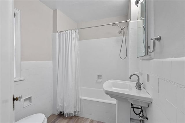 7224 Ward Pkwy, Kansas City, MO 64114 - bathroom with tile walls, shower / tub combo, toilet, wood finished floors, and wainscoting