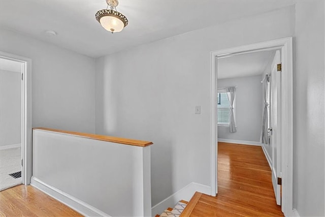 7224 Ward Pkwy, Kansas City, MO 64114 - corridor featuring an upstairs landing, wood finished floors, and baseboards