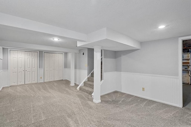 7224 Ward Pkwy, Kansas City, MO 64114 - finished below grade area featuring a textured ceiling, a wainscoted wall, carpet floors, stairs, and recessed lighting