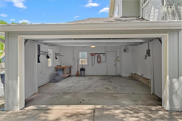 7224 Ward Pkwy, Kansas City, MO 64114 - garage featuring concrete driveway and central AC