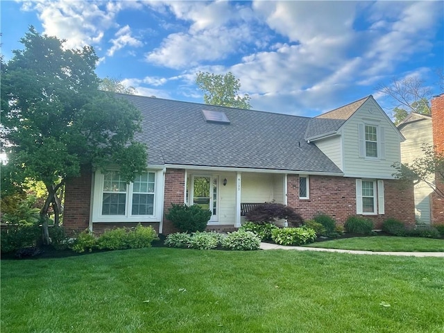 8122 Parkhill Rd, Lenexa, KS 66215 - traditional-style house with a front lawn, brick siding, a shingled roof, and covered porch