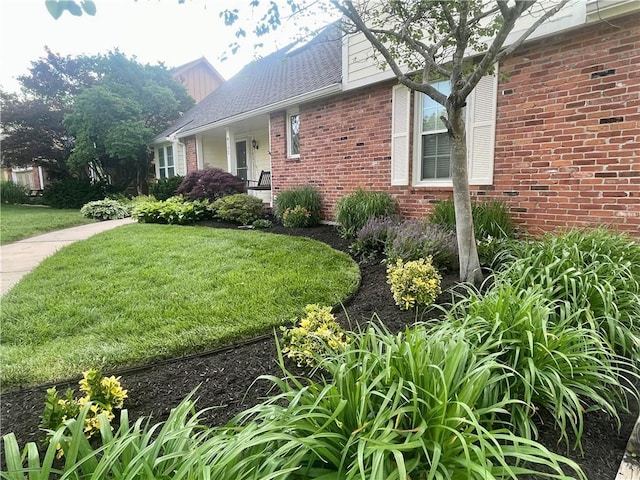8122 Parkhill Rd, Lenexa, KS 66215 - view of side of home with brick siding and a lawn