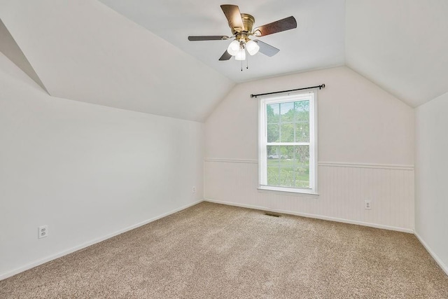 8122 Parkhill Rd, Lenexa, KS 66215 - additional living space with vaulted ceiling, carpet floors, and a ceiling fan