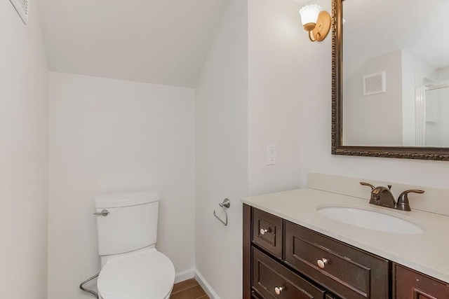 8122 Parkhill Rd, Lenexa, KS 66215 - bathroom with vanity, toilet, a shower with door, baseboards, and vaulted ceiling