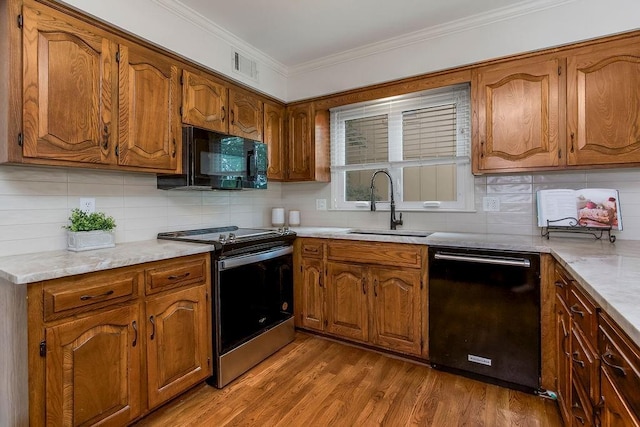 8122 Parkhill Rd, Lenexa, KS 66215 - kitchen with black appliances, a sink, brown cabinetry, decorative backsplash, and crown molding
