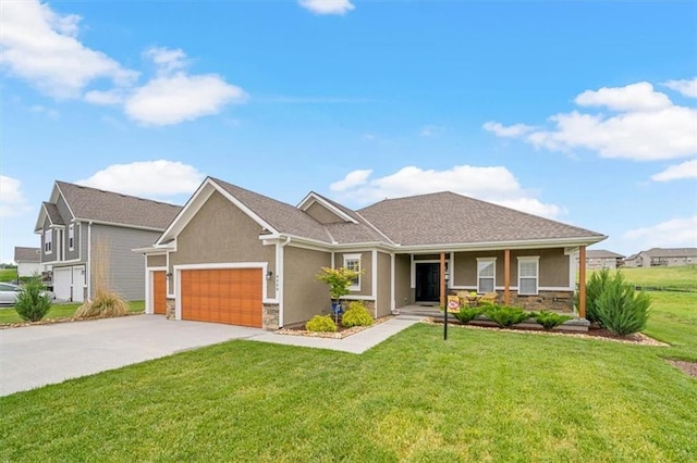 4500 Valley Ridge Dr, Saint Joseph, MO 64505 - view of front of property featuring a garage, stucco siding, a front lawn, and stone siding
