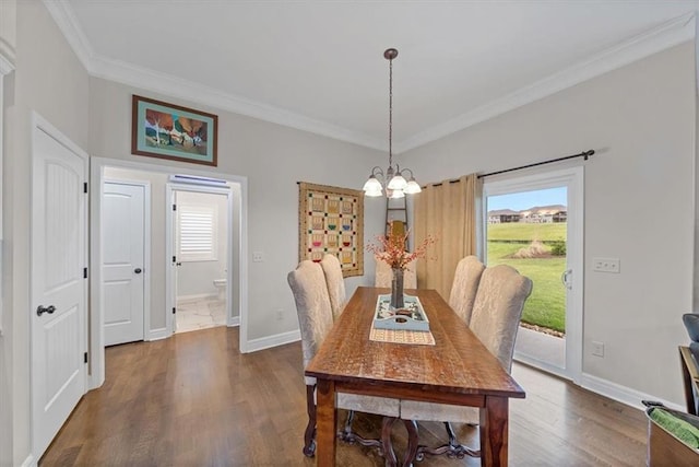 4500 Valley Ridge Dr, Saint Joseph, MO 64505 - dining area with ornamental molding, a chandelier, dark wood finished floors, and baseboards