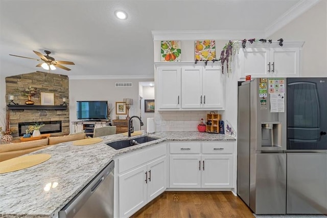 4500 Valley Ridge Dr, Saint Joseph, MO 64505 - kitchen with stainless steel appliances, a sink, crown molding, light stone counters, and ceiling fan