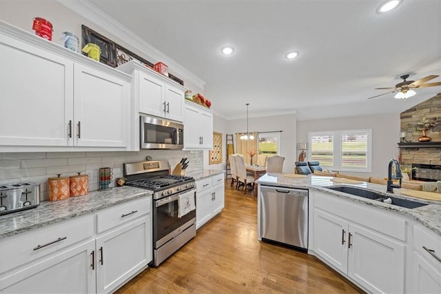 4500 Valley Ridge Dr, Saint Joseph, MO 64505 - kitchen featuring appliances with stainless steel finishes, a sink, tasteful backsplash, ceiling fan, and crown molding