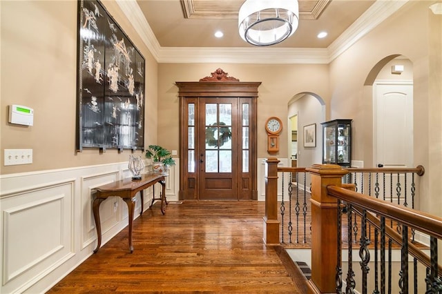 3116 W 137th St, Leawood, KS 66224 - entrance foyer featuring arched walkways, wood finished floors, ornamental molding, a decorative wall, and a wainscoted wall