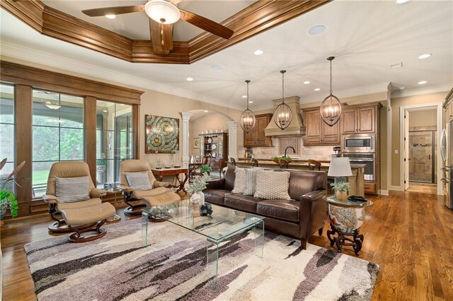 3116 W 137th St, Leawood, KS 66224 - living room featuring ornate columns, a ceiling fan, ornamental molding, recessed lighting, and arched walkways