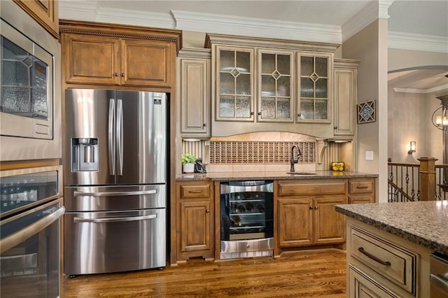 3116 W 137th St, Leawood, KS 66224 - kitchen with appliances with stainless steel finishes, beverage cooler, a sink, backsplash, and stone countertops