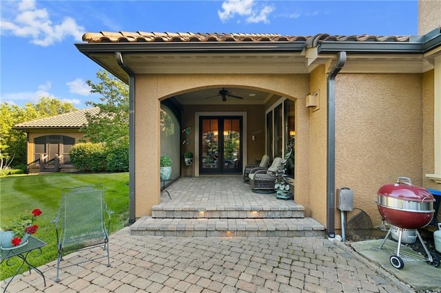 3116 W 137th St, Leawood, KS 66224 - entrance to property featuring french doors, stucco siding, a patio, and a ceiling fan