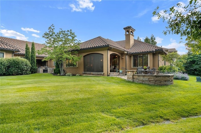 3116 W 137th St, Leawood, KS 66224 - back of house with a tiled roof, a chimney, a yard, and stucco siding