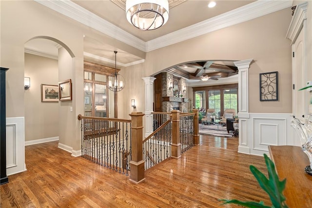 3116 W 137th St, Leawood, KS 66224 - hall with arched walkways, coffered ceiling, crown molding, wood finished floors, and an upstairs landing