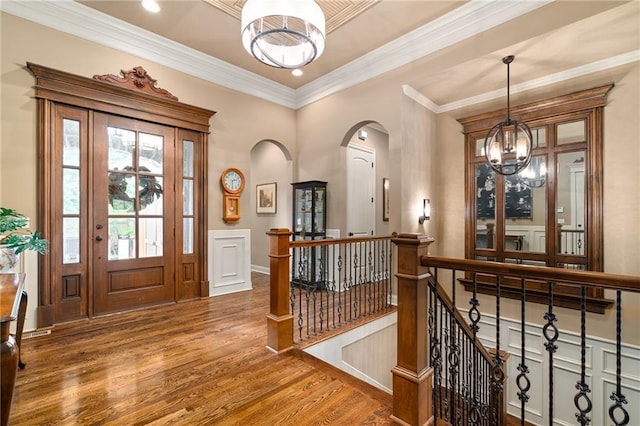 3116 W 137th St, Leawood, KS 66224 - entryway featuring a chandelier, wood finished floors, arched walkways, crown molding, and recessed lighting