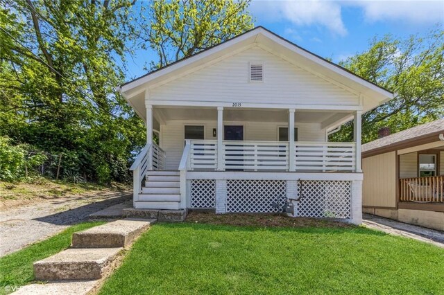 2015 Rowland Ave, Kansas City, KS 66104 - view of front of house with covered porch and a front yard