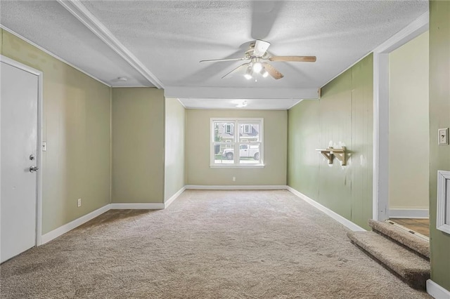 906 W 84th St, Kansas City, MO 64114 - empty room with a ceiling fan, carpet, a textured ceiling, and baseboards